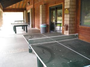 a ping pong table on the outside of a house at San Benito Camping Resort One-Bedroom Cabin 9 in Paicines