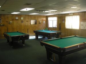 two pool tables in a room with wooden walls at Pio Pico Camping Resort Two-Bedroom Cabin 12 in Jamul
