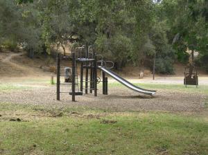 a playground with a slide in a park at San Benito Camping Resort Cottage 11 in Paicines