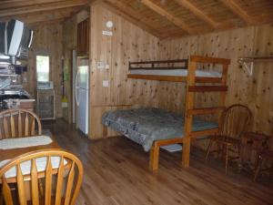 a room with a bunk bed and a kitchen at Pio Pico Camping Resort Studio Cabin 10 in Jamul