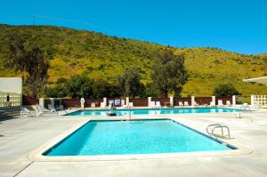 a swimming pool with a mountain in the background at Pio Pico Camping Resort One-Bedroom Cabin 13 in Jamul