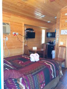 a bedroom with a bed in a wooden cabin at Pio Pico Camping Resort Studio Cabin 7 in Jamul