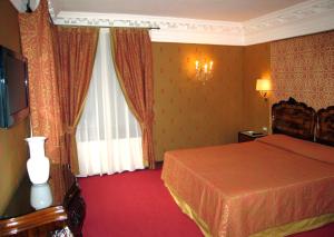 a hotel room with a bed and a television at Cà Bollani in Venice