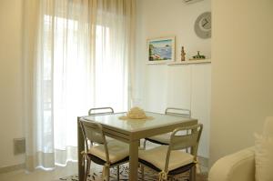a table and chairs in a room with a window at Apartment Serena in Alassio