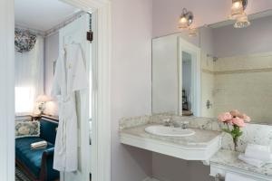 a bathroom with a sink and a mirror at The Queen Victoria in Cape May