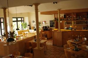 a restaurant with wooden tables and chairs in a room at Hotel Zum Abschlepphof in Leipzig