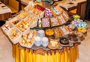 リニャーノ・サッビアドーロにあるHotel Al Praterの様々なペストリーやデザートを取り揃えたテーブル