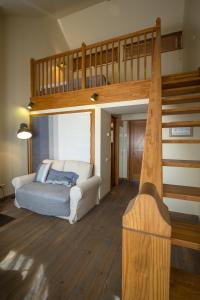 a living room with a loft bed and a couch at Rožmalas in Ceraukste