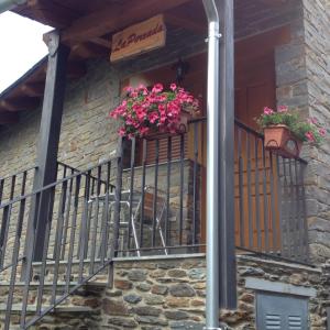 a balcony with two flower boxes on a house at La Perxada de Besolí in Areu