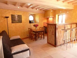 a living room with a couch and a table and a kitchen at le gîte de viré in Viré