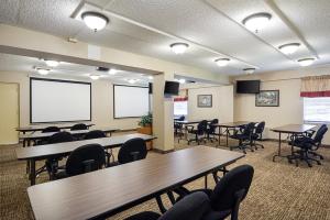 a conference room with tables and chairs and a projection screen at Quality Inn Winchester in Winchester