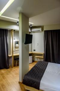 a bedroom with a bed and a desk at Agamemnon Hotel in Nafplio