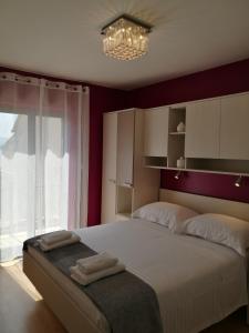 a bedroom with a large bed with two towels on it at Apartments Benika in Bol