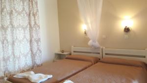 a bedroom with two beds and a window at Arillas Dream Studios in Arillas
