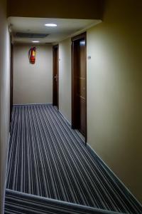 an empty hallway with a door and a corridorngthngthngthngthngthngthngth at Agamemnon Hotel in Nafplio