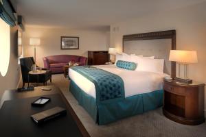 a hotel room with a large bed and a desk at The Edgewater in Madison