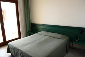 Postel nebo postele na pokoji v ubytování Hotel Miralonga