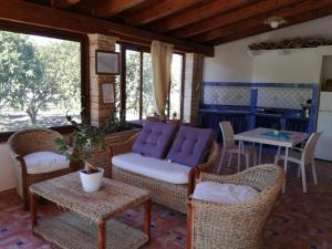 a living room with a couch and chairs and a table at Casa Nunna in Palma di Montechiaro