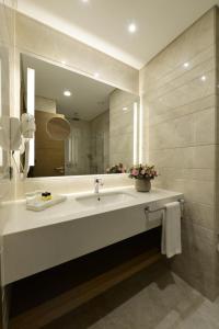 a bathroom with a sink and a mirror at Holiday Inn Bursa - City Centre by IHG in Bursa