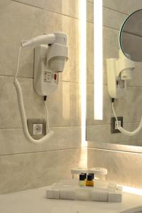 a bathroom with a hair dryer and a mirror at Holiday Inn Bursa - City Centre by IHG in Bursa