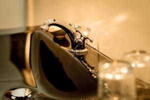 a sink with a faucet in front of a mirror at Chateau La Mothe du Barry in Moulon-sur-Dordogne