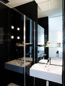 a bathroom with a sink and a bath tub at VISIONAPARTMENTS Waffenplatzstrasse - contactless check-in in Zürich