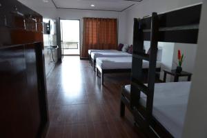 Postel nebo postele na pokoji v ubytování Globetrotter Inn - Palawan Inc.