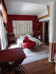 a bedroom with a bed with a red wall at Forte House in Milan