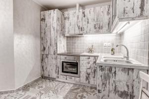 a kitchen with wooden cabinets and a sink at Belone Suite in Corfu