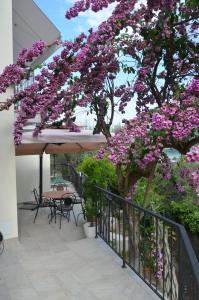 a tree with purple flowers on a balcony at Casa Gaia in Lerici
