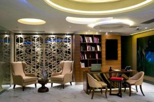 a lobby with a library with chairs and a desk at Taba Luxury Suites and Hotel in Istanbul