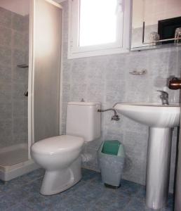 a bathroom with a toilet and a sink at Hotel Perama in Perama