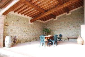 a patio with a table and chairs in a building at Francesca Apartment in Montelupo Fiorentino