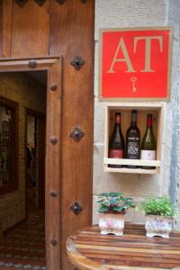 a sign on the side of a building with bottles of wine at Ganbara in Puente la Reina