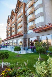 a large building with a lawn in front of it at Radisson Hotel & Convention Center Edmonton in Edmonton