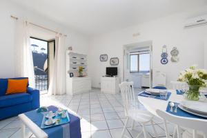 a living room with a blue couch and a table at Appartamento Cassano Blu in Piano di Sorrento