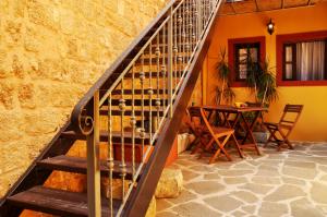 a staircase in a room with a table with wine bottles at Antifanous Apartments in Rhodes Town