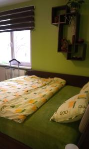 A bed or beds in a room at Green Apartment