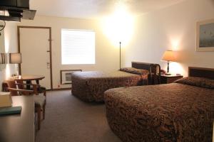 a hotel room with two beds and a table at The Lake House Inn in Laurie