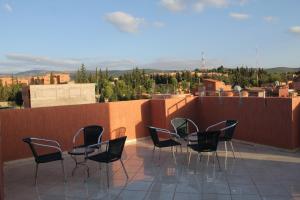 a group of chairs sitting on top of a roof at Appart'hotel Dior Lamane in Azilal