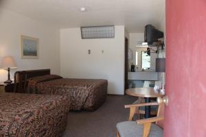 a hotel room with two beds and a table at The Lake House Inn in Laurie