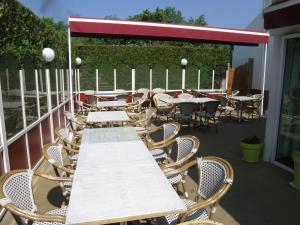 a row of tables and chairs on a patio at Dolce Vita in Bruay-la-Buissiere