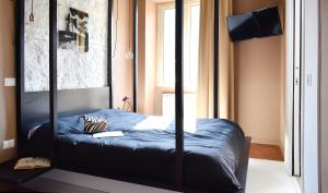 a bedroom with a canopy bed with a window at Bibi e Romeo's Home in Rome