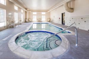 a large indoor pool with a hot tub in a building at Grand Vista Hotel Parachute in Parachute