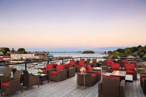 a deck at a hotel with chairs and tables at 16 Bay View in Camden