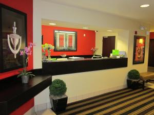 a lobby with a reception desk and red walls at Extended Stay America Suites - Pleasant Hill - Buskirk Ave in Pleasant Hill