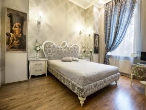 a room with a bed, table, chairs and a window at City Garden Apartments in Odesa