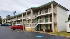 a red truck parked in front of a building at American Inn Columbia in Columbia