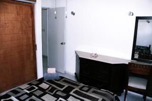 a room with a desk and a mirror and a door at Casita Aurora in Chemuyil