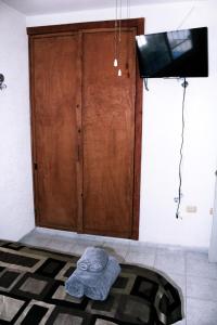 a large wooden door with a rug in front of it at Casita Aurora in Chemuyil +9 photos